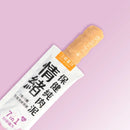 白色包裝情緒保健純肉泥，印有黑色中文字與橘色標籤，擠壓出濃稠肉泥質地.