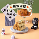 法國奶油蛋捲配海苔與肉鬆，擺放於石紋圓盤，背景有撲克牌與骰子裝飾.