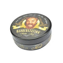黑色圓形髮蠟罐，蓋子有騎士插畫及金色BARBERSTATION字樣.